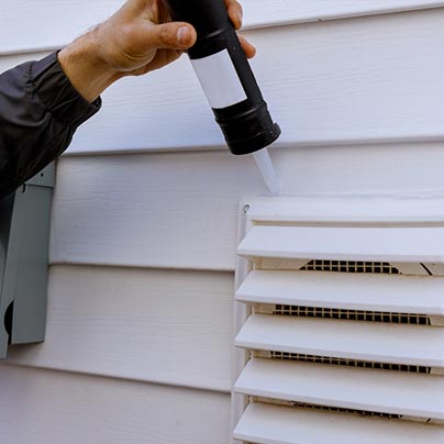 Man checking home air vents